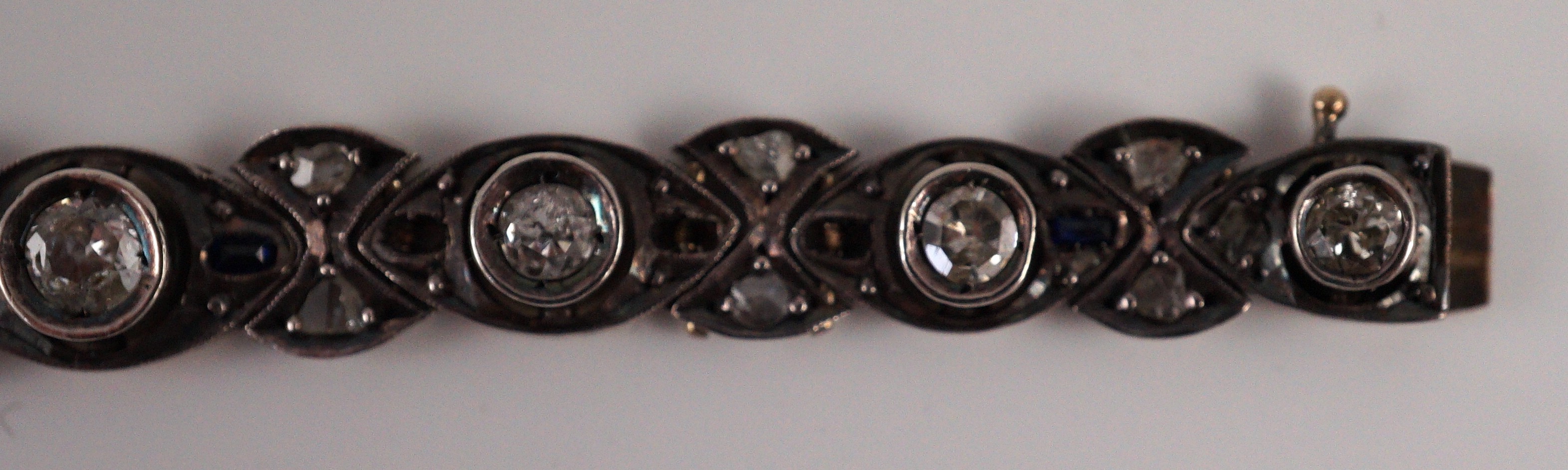 An early to mid 20th century continental gold and silver, graduated diamond and sapphire set line bracelet